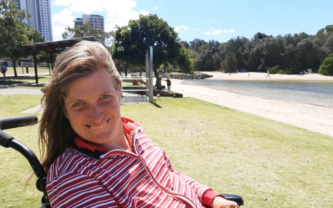 Carly smiling by the water