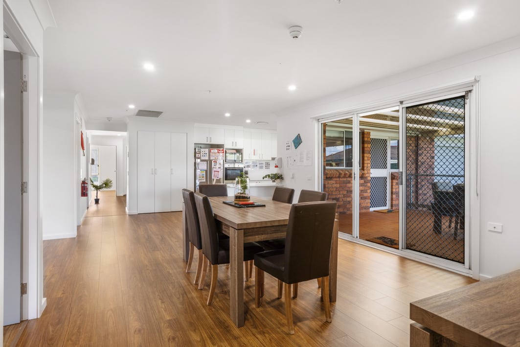 Dining area with wooden dining table and black chairs