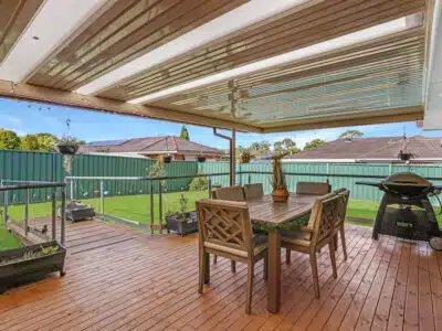 Undercover outdoor entertainment area with a barbeque, table and seating