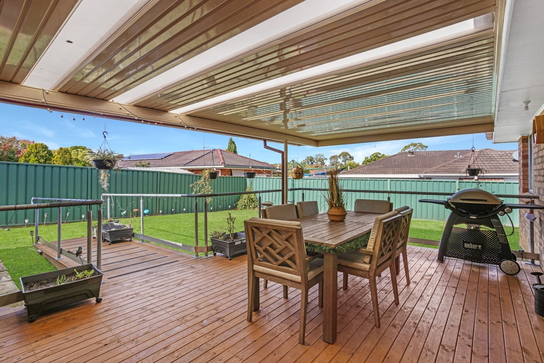 Undercover outdoor entertainment area with a barbeque, table and seating