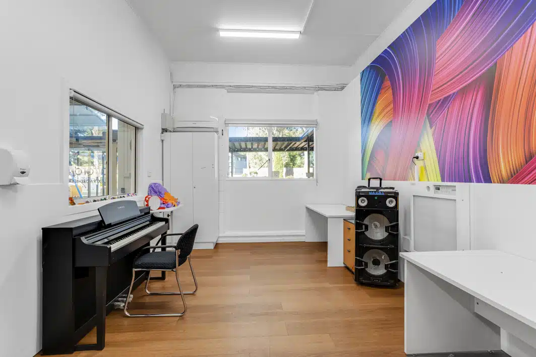 Music room with a piano and large speaker.