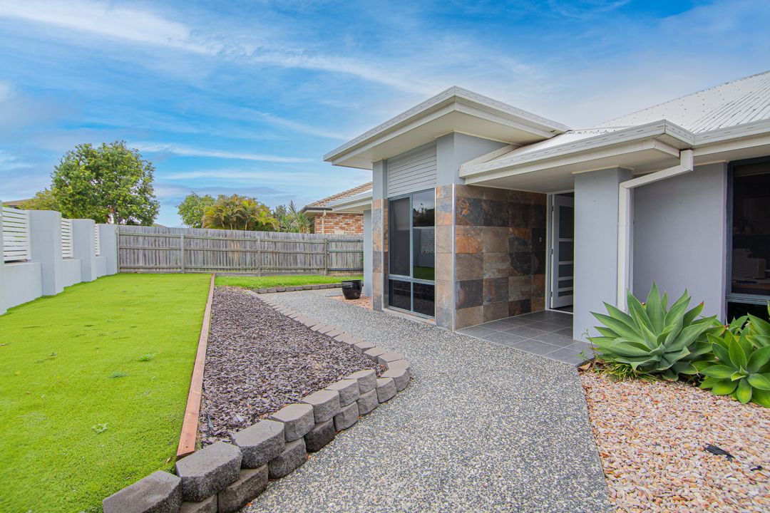 Wide pathway leading to the entrance of a large SIL house.