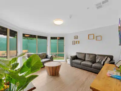 Living room with leather sofas, coffee table and television