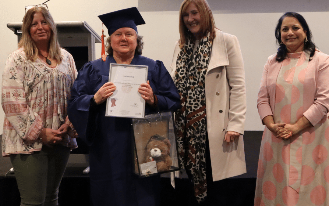 Supported employee Linda Romig presented with qualification