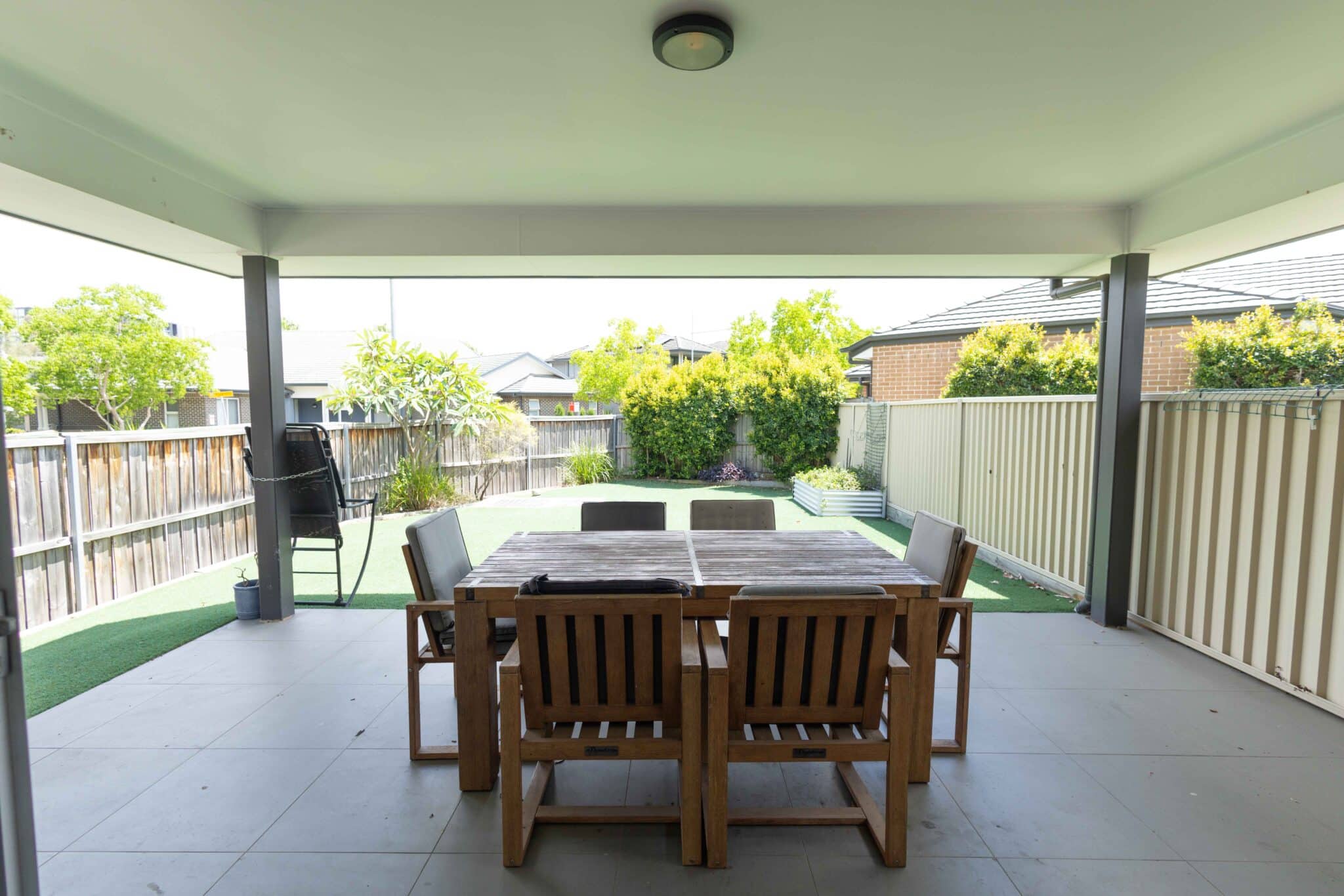 Backyard area with wooden table and chairs