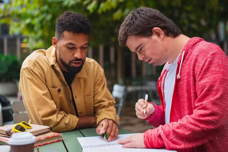 Support worker helping client fill out a form